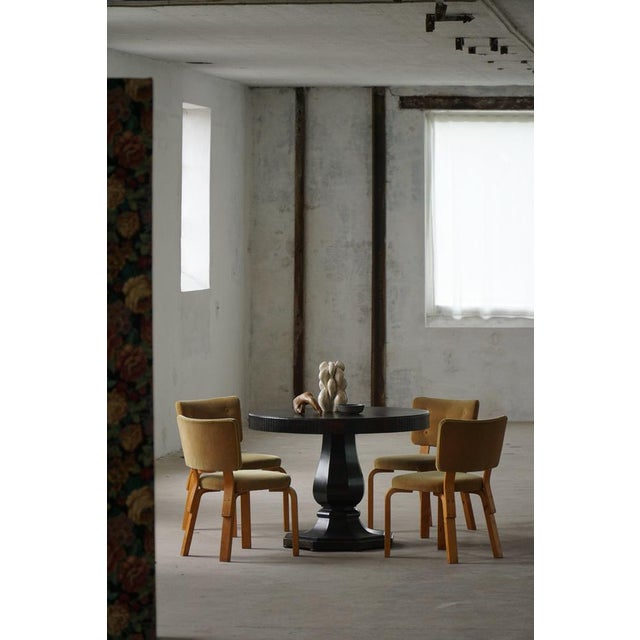 Elegant Danish art deco dining table crafted in solid oak with a rich ebonized finish. The round tabletop is accented by a...