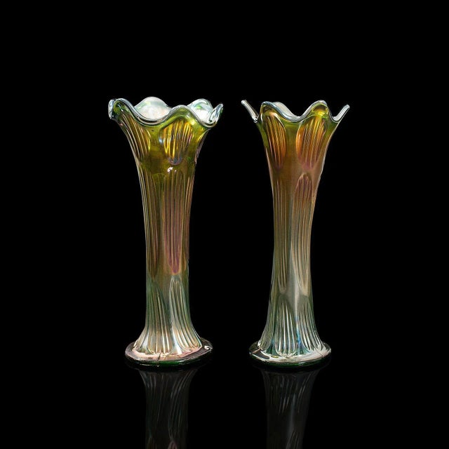 This is a pair of vintage decorative flower vases. An English, carnival glass vase, dating to the early 20th century,...