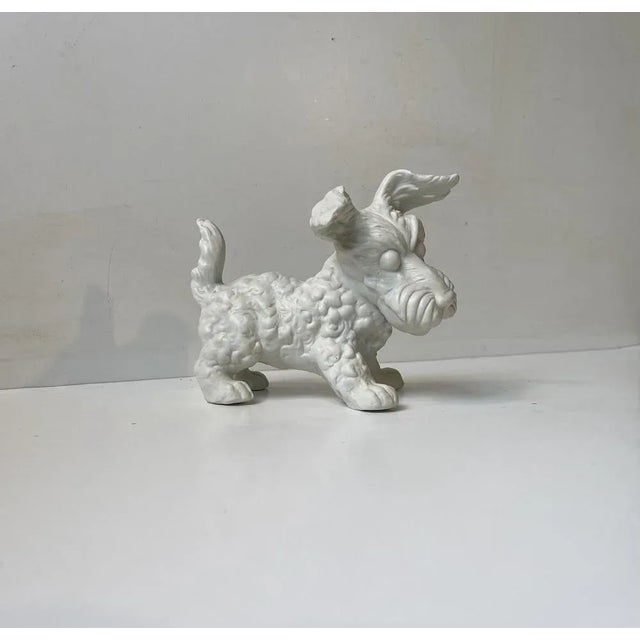 Lifelike figurine of a white Scottish terrier. Its executed and molded in white bisque porcelain. This is the large size...