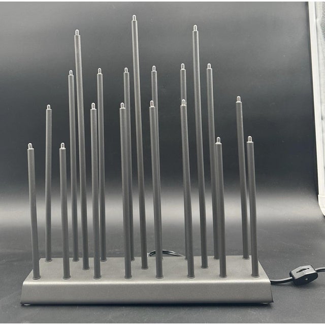 Measures approximately 14 7/8 inches tall to top of tallest candle rod light. Rectangular base measures 3 1/2 by 12 1/2 by...