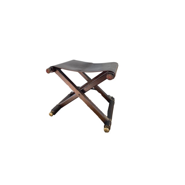 Mid Century Folding Leather Sling Stool with wood frame, brass trim and coral beaded jewel trim detail. The relaxed sling...