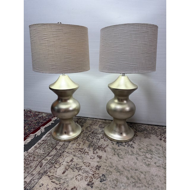 Design Plus Gallery presents a Pair of Sculpted Table Lamps with Contemporary Style. The lamps have a heavy base with high...