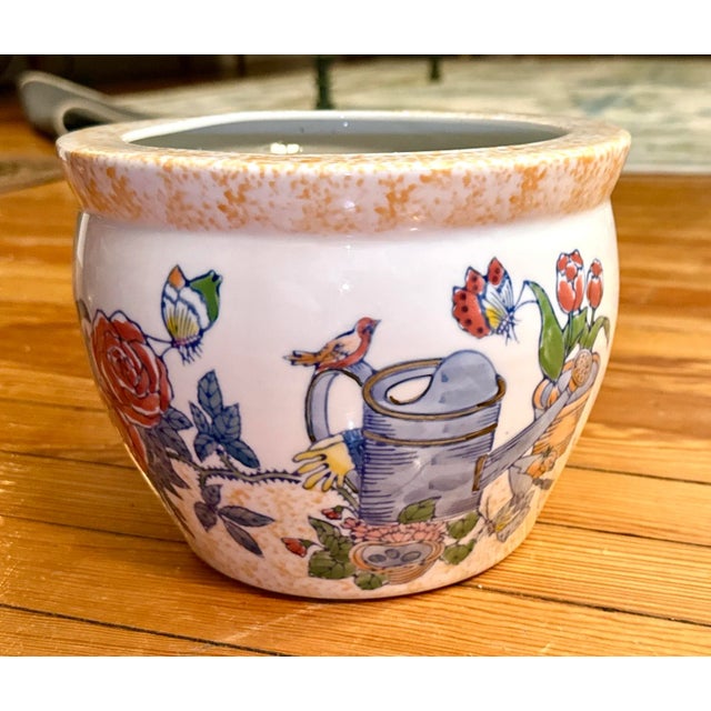 Pretty hand painted scene including fresh spring tulips, a watering can, roses and butterflies. A golden yellow pattern...