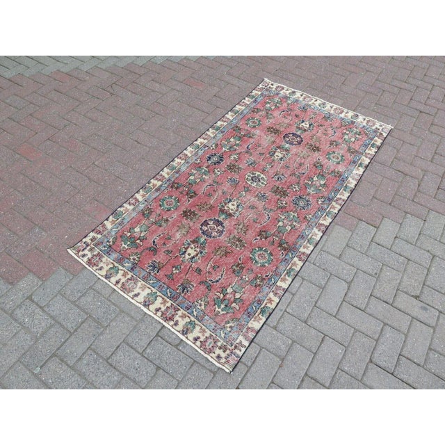This beautiful, traditional vintage, hand knotted Turkish area rug is approximately 60 years old. It is handmade of very...