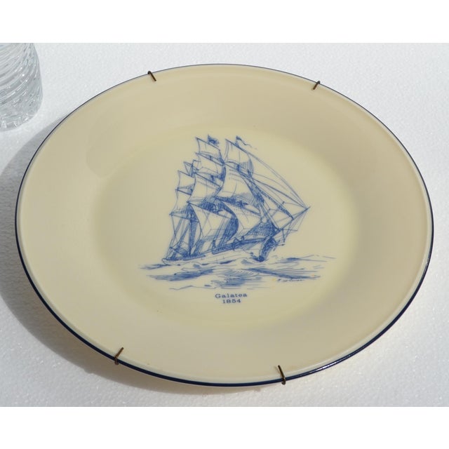 The 1950s Lenox Galatea 1854 Decorative Plate is a collectible ceramic plate featuring a ship motif, gold trimming, and a...