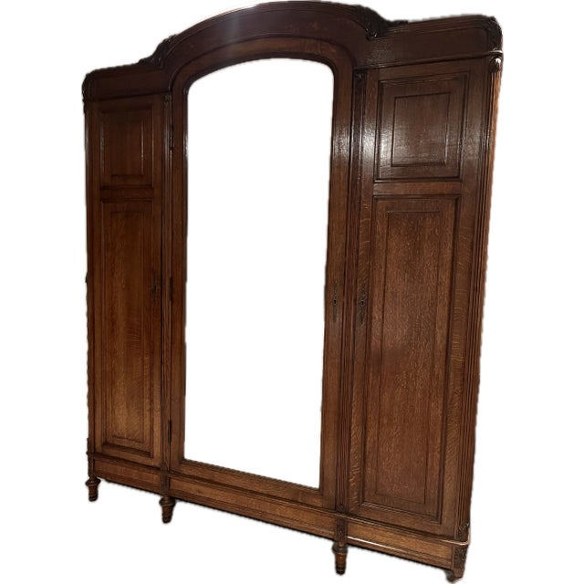 Anitque Solid Wood 3- Door Wardrobe 1920-30s with full length mirror, shelving and railing for hanging clothes. Includes...