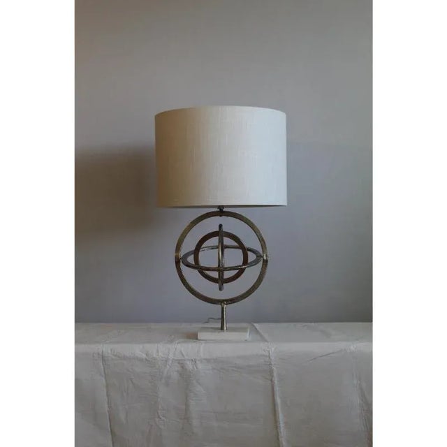 Unusual unisphere table lamp. Inherent of the Mid Century modern movement.Constructed of cast nickle and marble. Spheres...