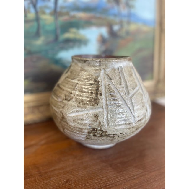 This signed handcrafted studio pottery vase features a globular form with a narrow opening and a warm, earthy glaze in...