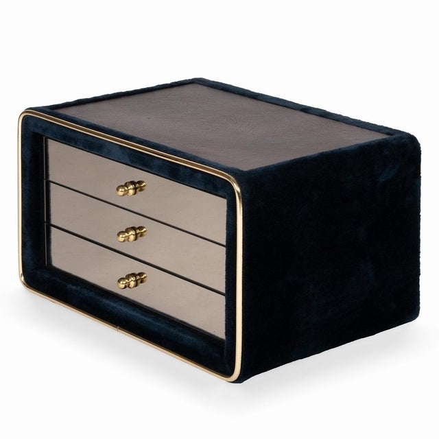 A luxurious bedside table made in the 1970s by the German company RUF International. The table has three pull-out drawers...