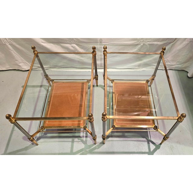 A pair of gilt bronze, brass, glass, and leather side tables, French work from the second half of the 20th century,...