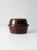 This is a vintage stoneware casserole dish. The brown glazed ceramic cookware features a ribbed design and lid with inset...