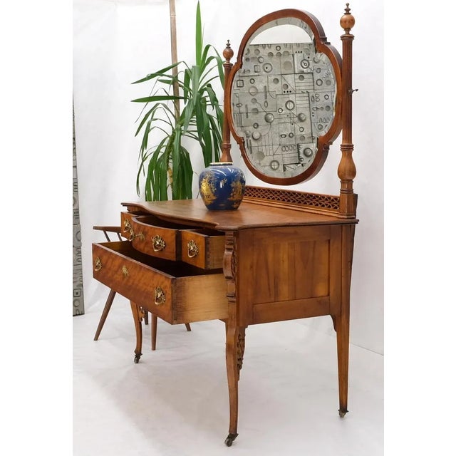 Antique tiger maple four drawers carved dresser. on tall legs circa 1880s. I large swivel beveled mirror of a stretched...