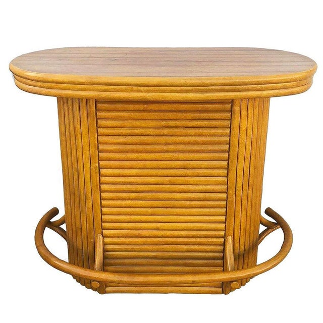 This beautifully restored Mid-century coastal 49" wide vertically stacked rattan oval shaped Mid-century dry bar. The bar...
