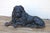 An impressive pair of 19th-century English cast iron lion andirons, featuring beautifully sculpted reclining lions with...
