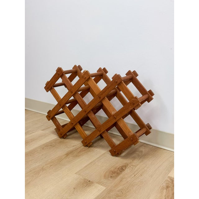 This clever and beautifully crafted vintage MCM collapsible teak wine rack is a practical and good-looking bar and...