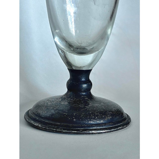 A beautiful antique Pairpoint cut glass vase featuring an elegant wheel-cut design on crystal-clear glass. The vase is...