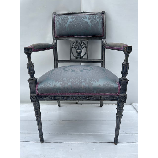 A single vintage carved wood French style fauteuil armchair with upholsteeed seat, back, and arms. The carved wood frame...
