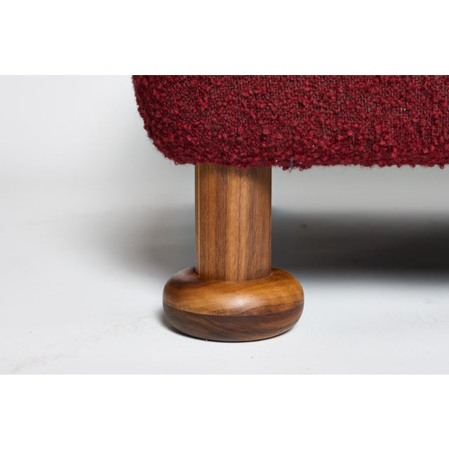 The BDDW Caubeen Sofa is a stylish piece with a unique red fabric design. • Features a plush, curved backrest • Supported...