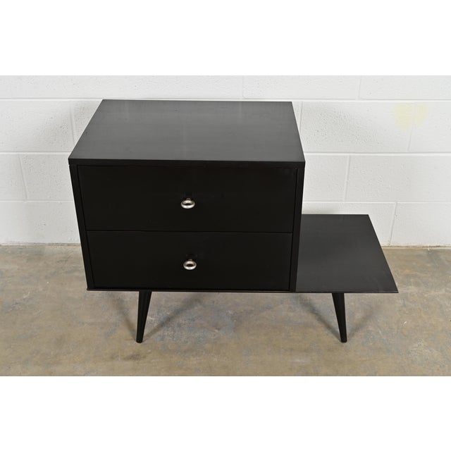 A sleek and stylish Mid-Century Modern two-piece modular dresser or chest of drawers on bench/table By Paul McCobb for...