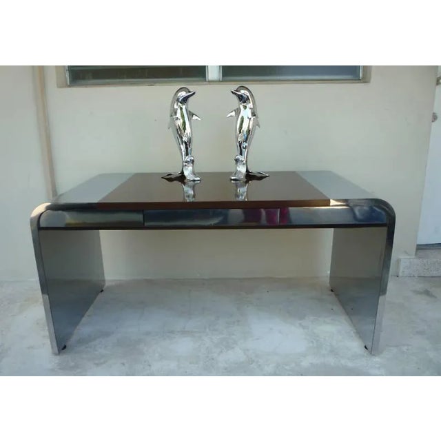 Pair of incredible 70's chromed brass swimming dolphins standing 29 inches high each, in very good condition. Great as is...