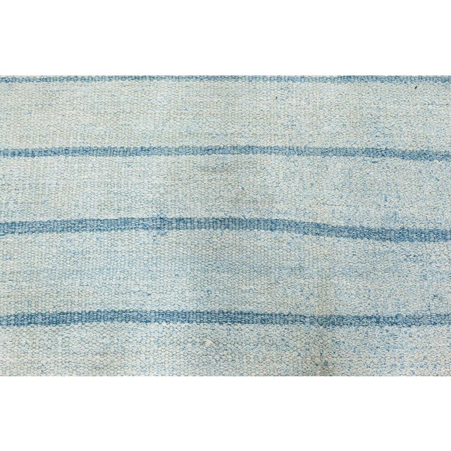 Vintage Indian Dhurrie striped blue rug Size: 6'5" × 7'2" (195 × 218 cm) A striking testament to the timeless appeal of...