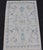 Measures: 1'10 x 3'0 Modern Oushak Rug with Soft Ivory Base and Delicate Sky Blue Floral 1'10 x 3'0. Keivan Woven Arts;...