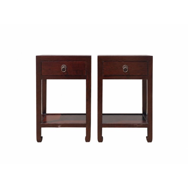 This pair of elegant Asian accent tables is handmade from solid elm. With a single drawer and four elegantly shaped legs...