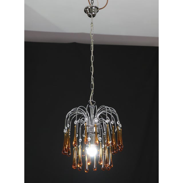 Set of 2 Gorgeous Murano chandelier in the style of Venini's La Cascata. The nickel-plated silver crown-shaped frame has...