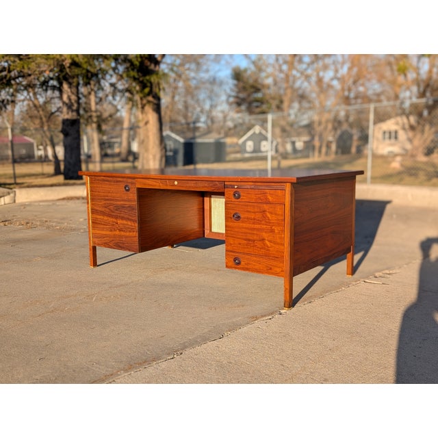 Walnut, cane, brass, and rosewood executive desk by Edward Wormley for Dunbar Furniture, circa 1950s. Massive desk with...