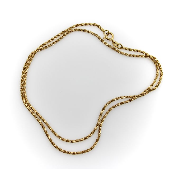 This vintage 18k gold chain necklace has the fluidity of a snake chain, but consists of woven links of bright-cut square...