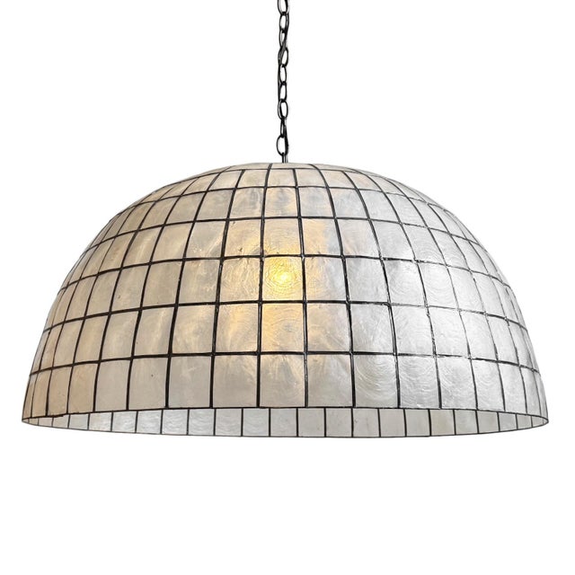Striking dome lantern made from delicate capiz shell square pattern bonded together with pewter finish metal. Each lantern...