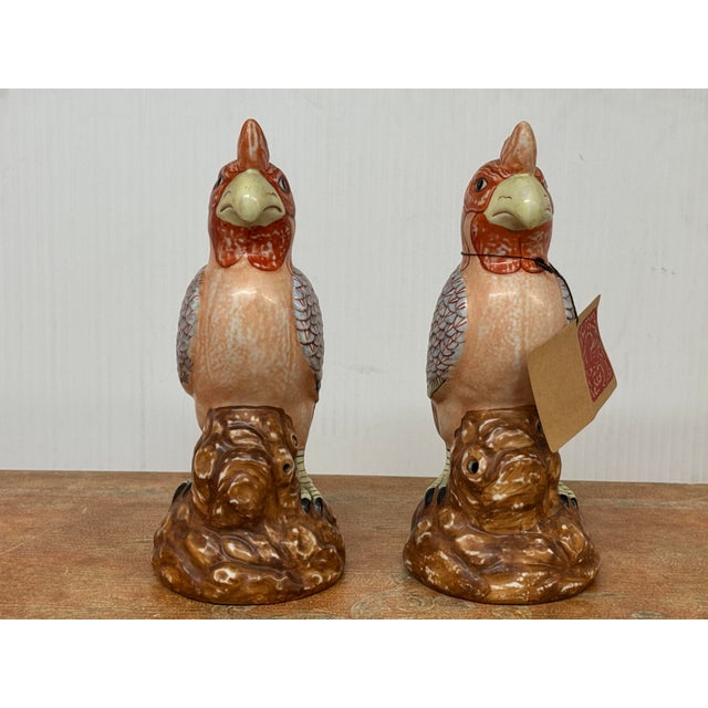 Design Plus Gallery presents a Set of Two Hand Painted Porcelain Parrots. The parrots have nearly identical features that...
