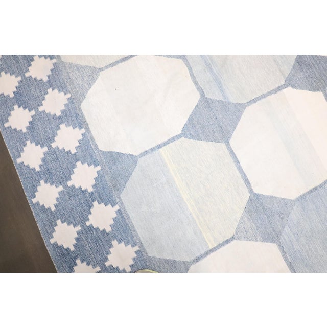 a large early 20th Century Indian Dhurrie rug in creams and light blue. some hints yellow. some minor spot stains which is...