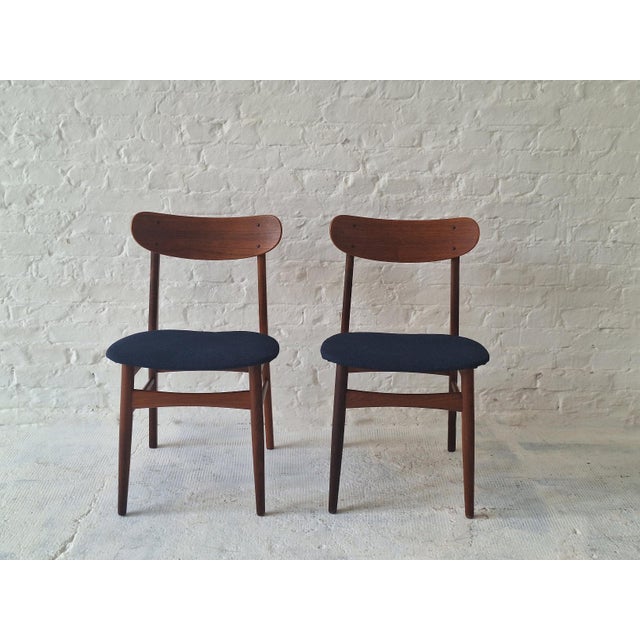 Finely constructed pair of 1960s Danish dining chairs in solid teak, seats recently re-covered with a structured navy blue...