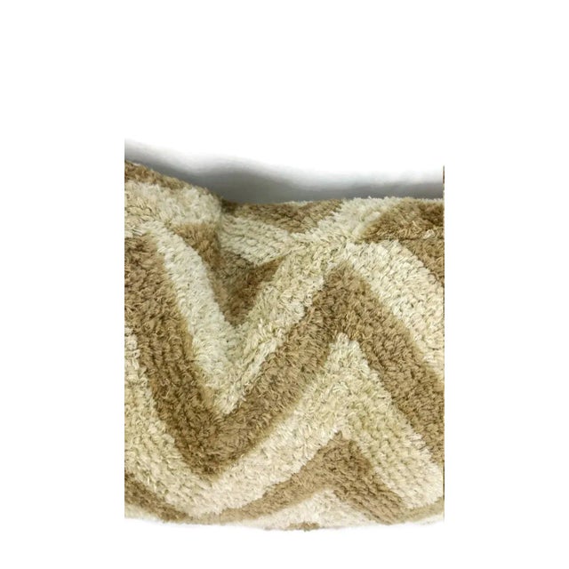 This pillow is made of 85% sunbrella acrylic which means that this can be used for outdoors. This is Donghia's Zigzag in...