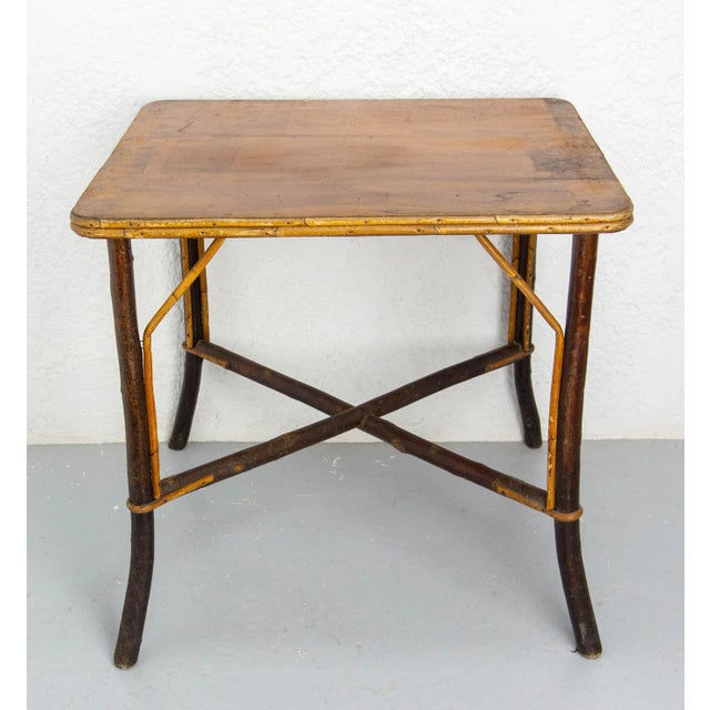 Rare side table with feet in hazel wood and rattan. The cabinetmaker has kept the bark of the wood for making the feet....