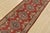 A tribal Caucasian Kazak runner hand-knotted with fine wool on a cotton foundation. This rug features geometric medallions...