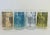 A set of 4 1950s Copenhagen drinking glasses decorated with stylized fishes outlined in black. The background colors of...