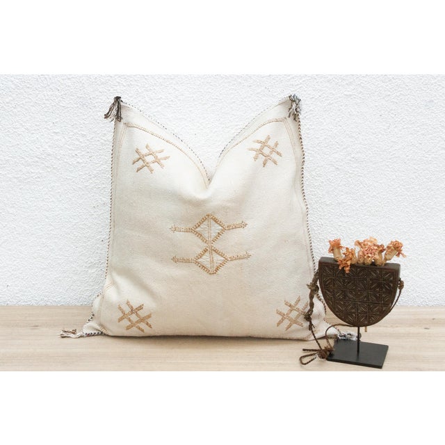 Indulge in the grounded beauty of our handcrafted Moroccan cactus silk pillow, measuring approximately 22 inches square....