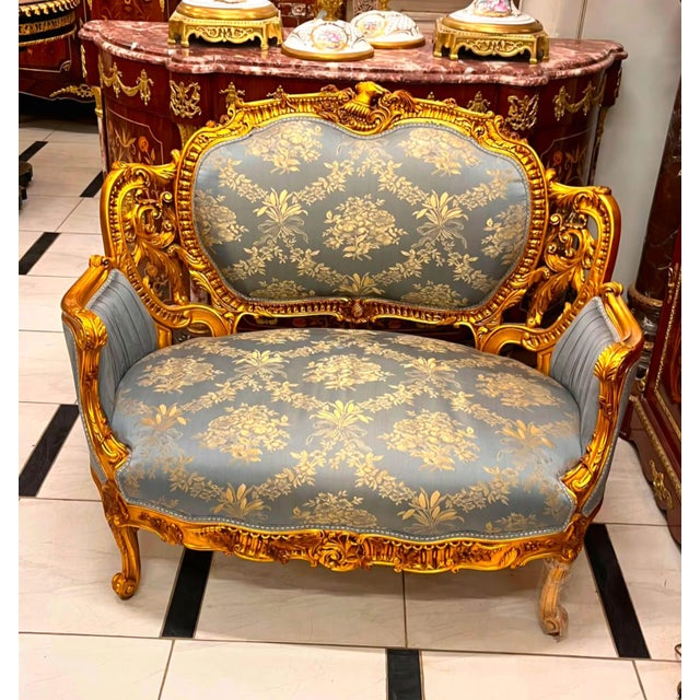 Elevate your home with the timeless beauty of this exquisite French Louis XV loveseat. Upholstered in an elegant powder...