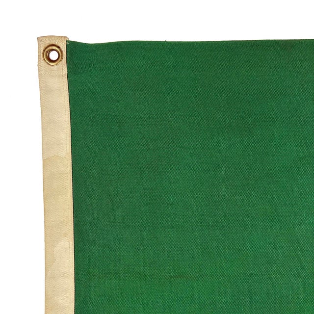 This vintage Mexican flag is made from a cotton cloth, with fully sewn panels and printed emblem visible on both sides....