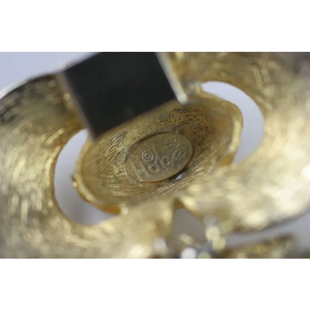 This is part of Chairish’s Costume Jewelry assortment. Striated goldtone double clamshell style bracelet with aurora...