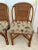 Pair of old Florida style rattan chairs with palm tree print fabric. Made in the Philippines