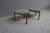 Pair of mid-century Jack Larsen style tripod footstools featuring colorful paisley upholstery and simple wooden legs....