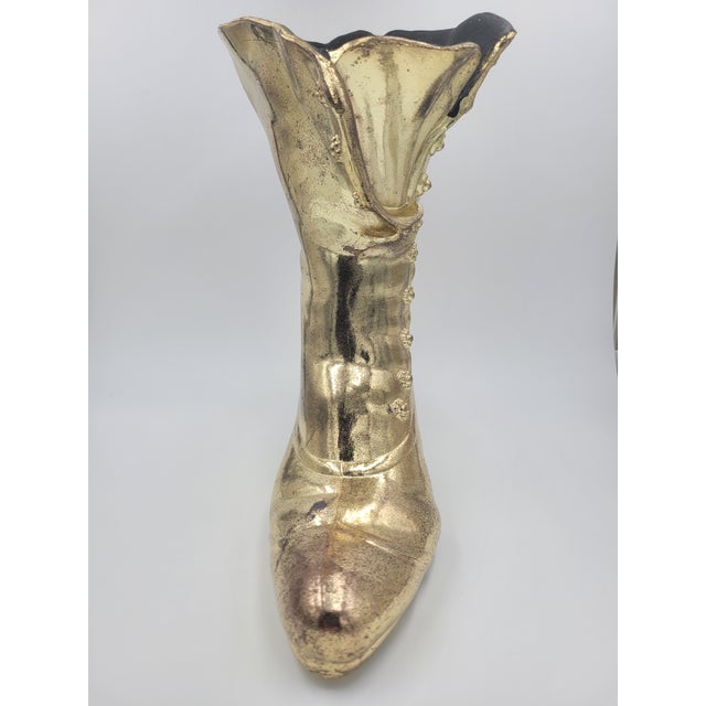This substantial Victorian-style "granny boot" is crafted from heavy cast iron with a classic gold-gilded finish. A...