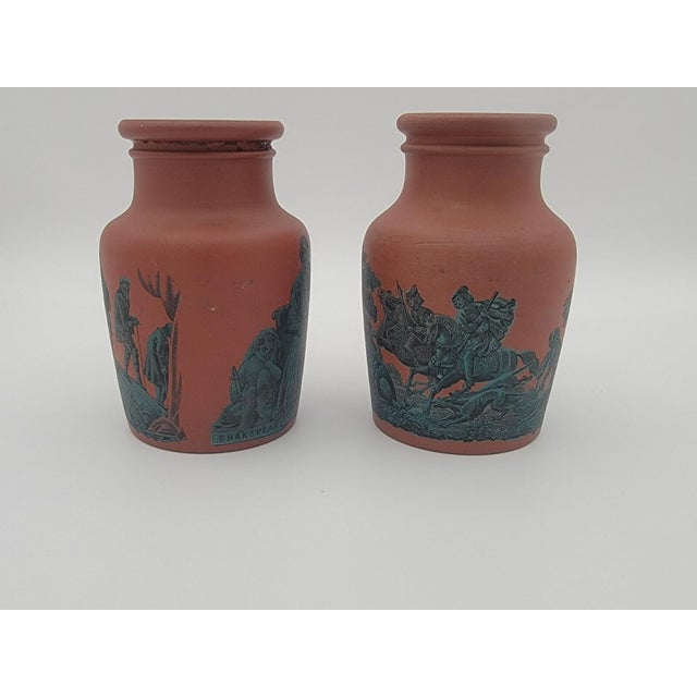 This is a pair of antique English Prattware transferware pottery potted meat jars dating back to the 1860s. The jars are...