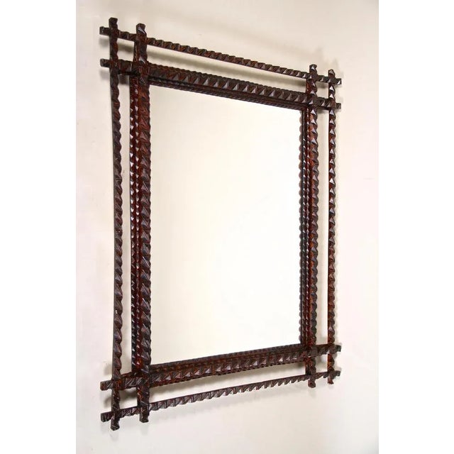 Fantastic Tramp Art Wall Mirror from the late 19th century in Austria around 1880. This rustic mirror has been elaborately...