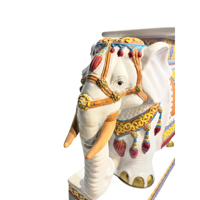 Vintage brightly colored glazed terracotta elephant garden stool. Bright earthenware tones of blue, green, yellow and red.