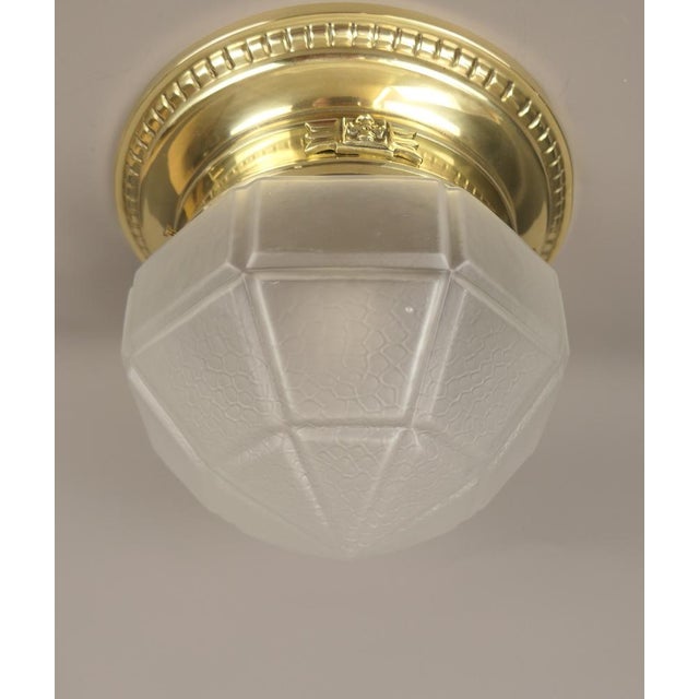 Brass ceiling lamp with mouth blown shade from 1920s The lamp gives a cosy, non-dazzling light. Polished surface. The lamp...