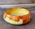 A strikingly beautiful ceramic bowl that looks as if it is dripping in orange flames. The slight crackle in the glaze...